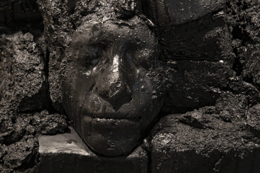 Image of a Black face etched in stone