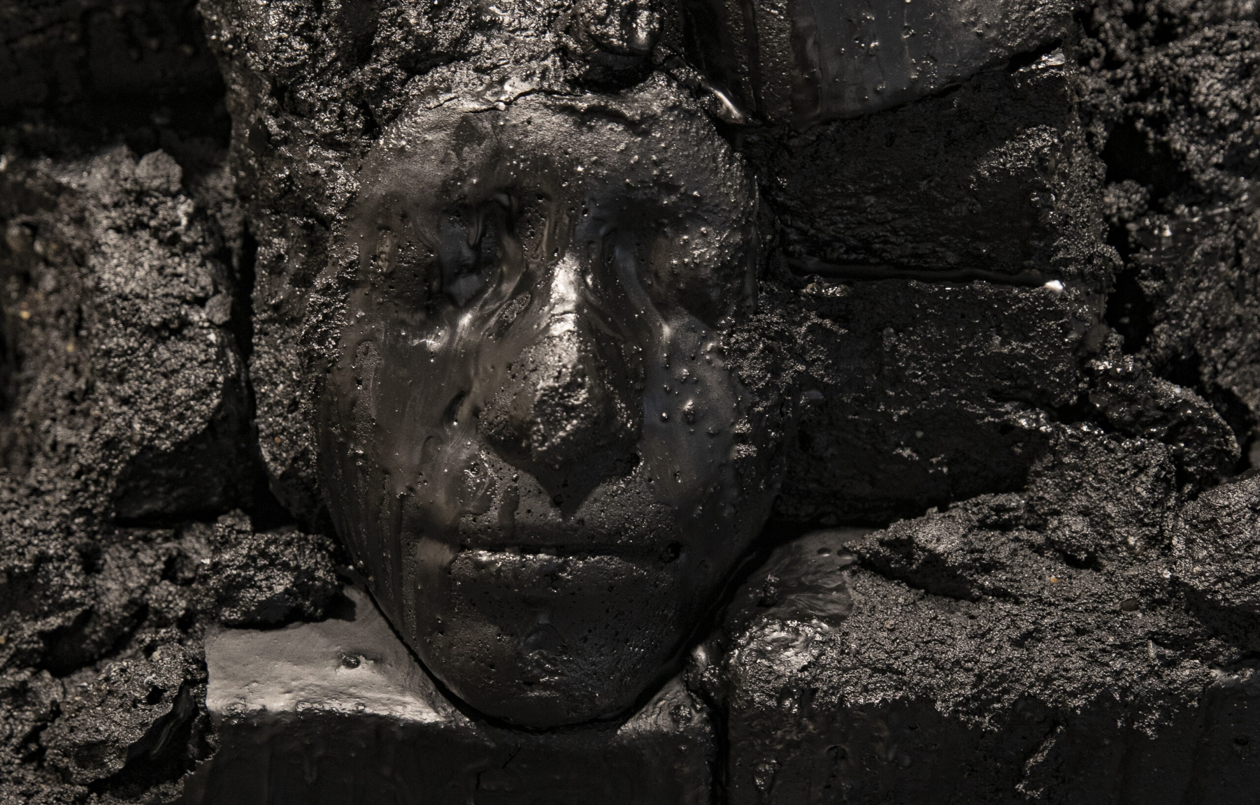 Image of a Black face etched in stone