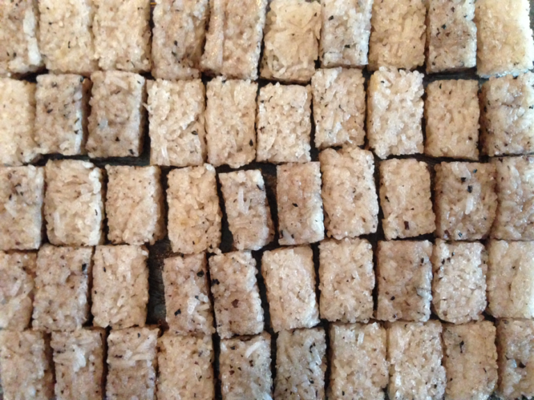 Close up photo of bricks of rice arranged in a grid like a wall.