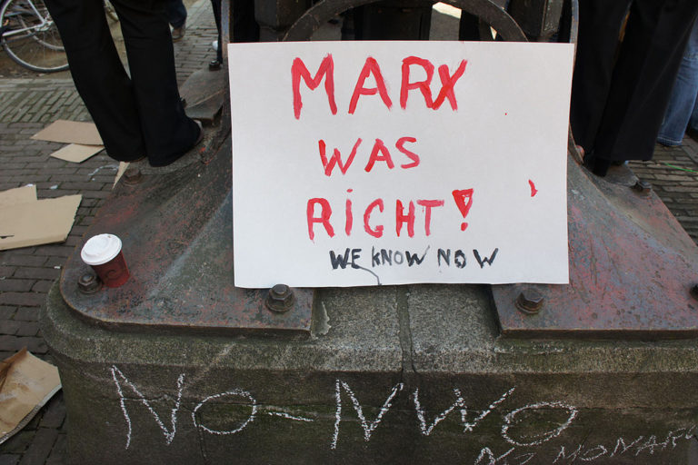 Photo of a sign saying "Marx was right! We know now"