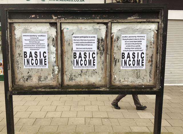 Basic income poster on old billboard
