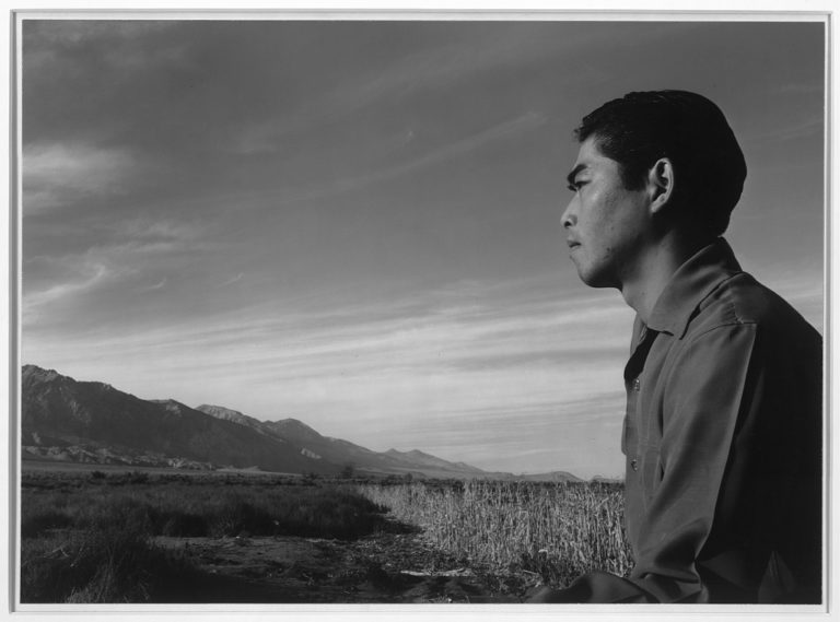 A profile of Tom Kobayashi, a Japanese American man, gazing at the Inyo Mountains in the Manzanar Relocation Center