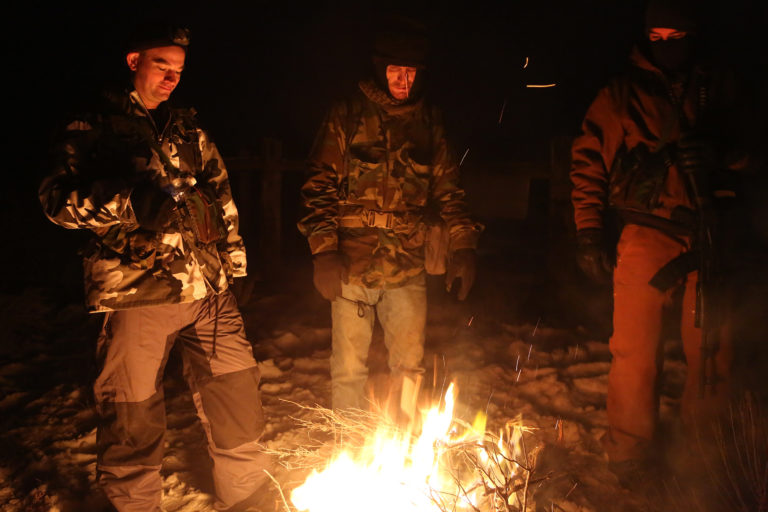 Armed occupiers at Malheur National Wildlife Refuge gather around a fire.