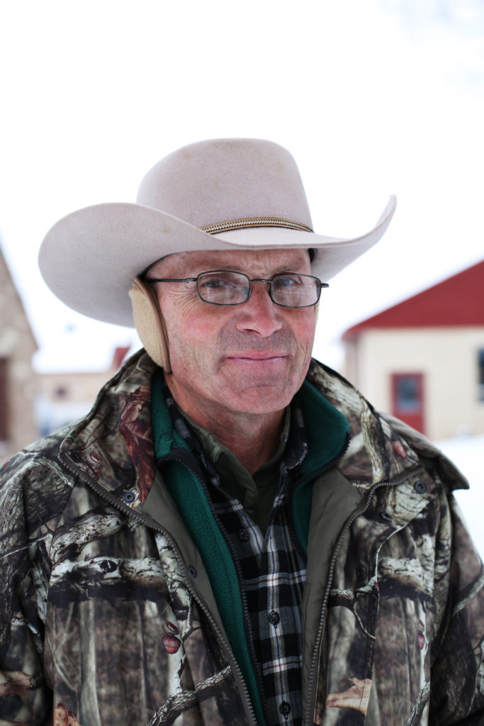 Portrait of LaVoy Finicum in a cowboy hat and camouflage hunting jacket.