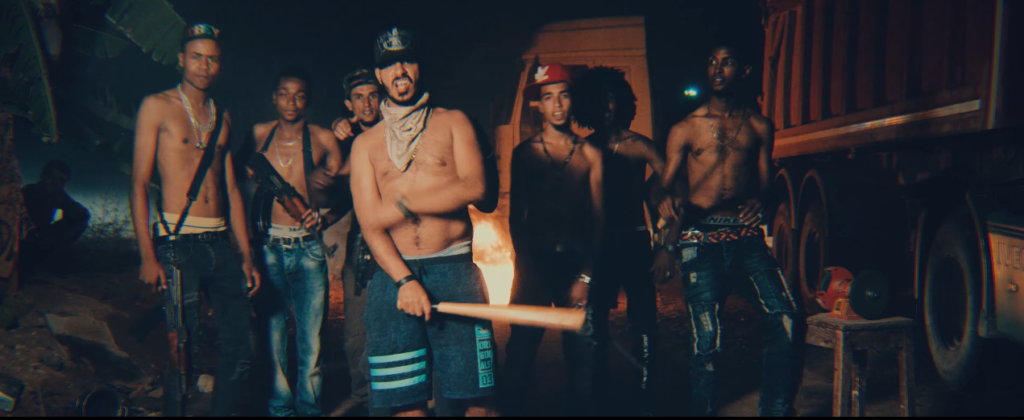 Rapper Ahmed Alshafee (center with baseball bat) and his posse of mostly Black Libyans pose with weapons and without shirts in the video for “Kish.”