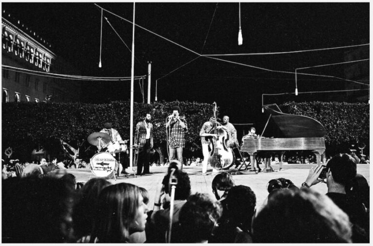 Black and white photograph of Archie Shepp Band on stage at PANAF with instruments