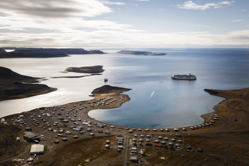 Photo of The Crystal Serenity at a stop in Ulukhaktok in the Inuvik region of Canada. Ulukhaktok had a population of 419 in 2016. The Crystal Serenity brings 1,000 passengers on its luxury liner.