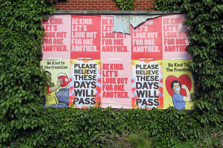 A wall of posters in Sheffield, UK, urges people to practice kindness and solidarity amidst the COVID-19 pandemic