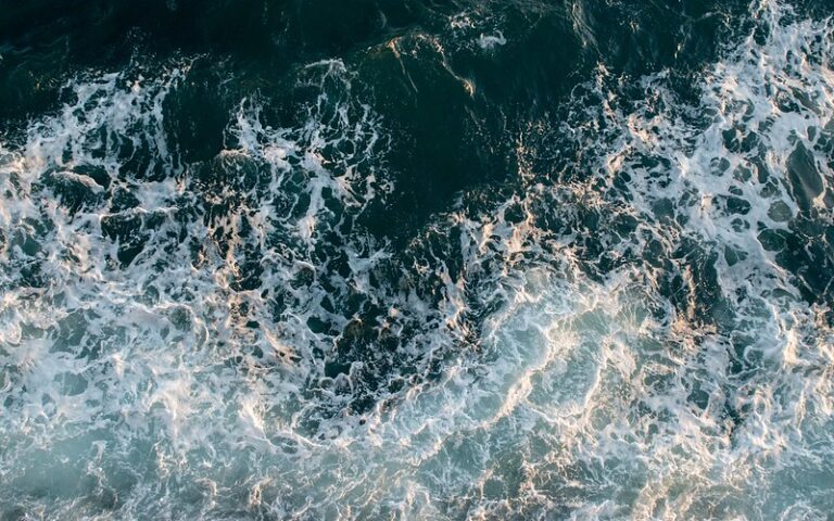 Aerial photo of waves in a body of water