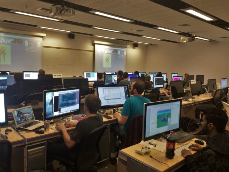 Photo of gamemakers in front of computers, arranged in rows