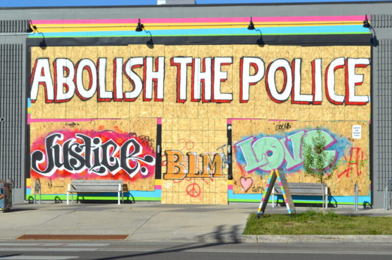 Graffiti from June 2020 in Minneapolis reading "Abolish the Police", "Justice", "BLM", and "Love"