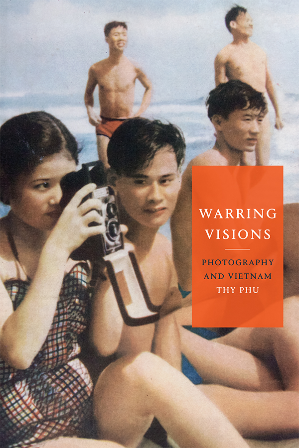 Photo of Vietnamese beachgoers with a woman holding up and looking through a camera. The book title and author name are superimposted.