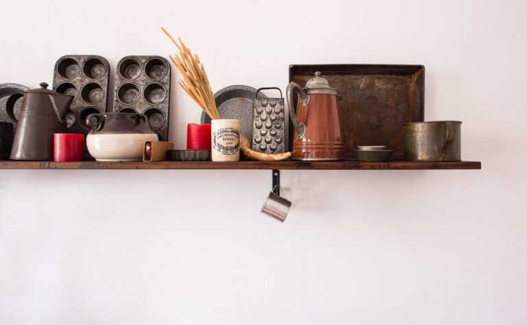 Kitchen utensils on a shelf.