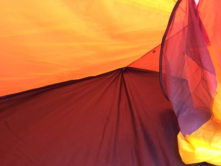 Interior of an orange and red tent.