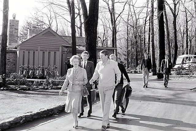 President Ronald Reagan during Prime Minister Margaret Thatcher of the United Kingdom's visit to Camp David with Charles Powell in the back ground.