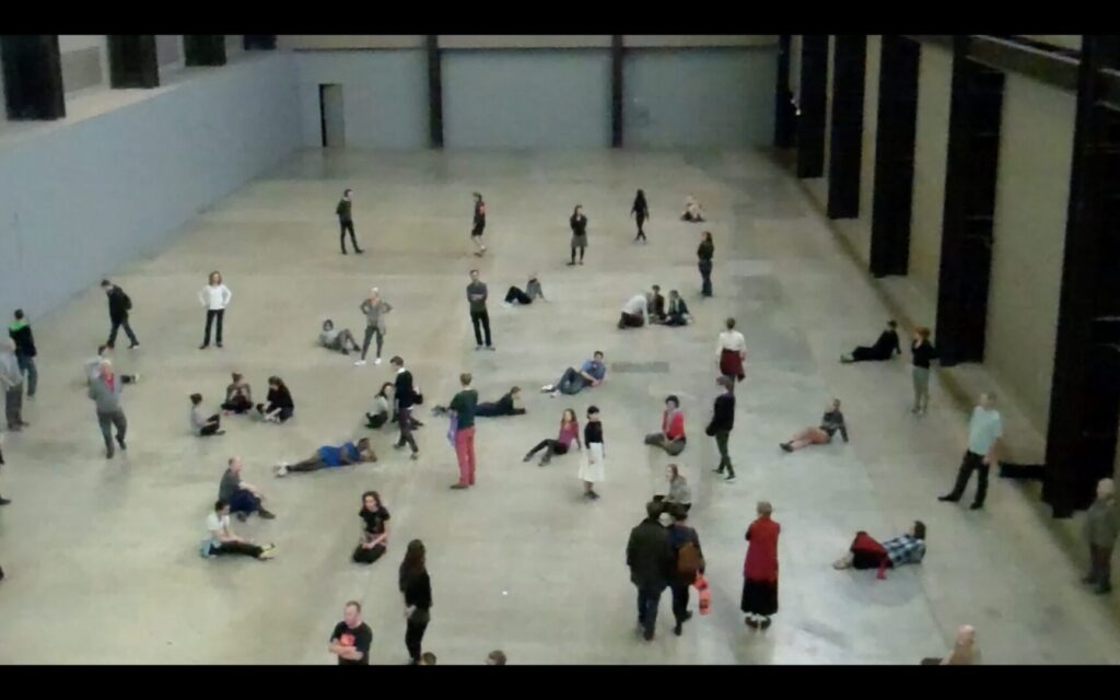 Performers posing in the Turbine Hall of the Tate Modern.