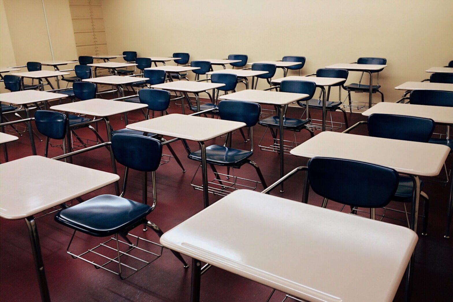 white school desk with stainless steel base and blue armchairs