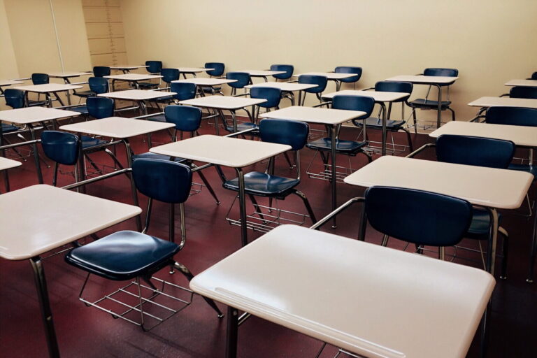 white school desk with stainless steel base and blue armchairs