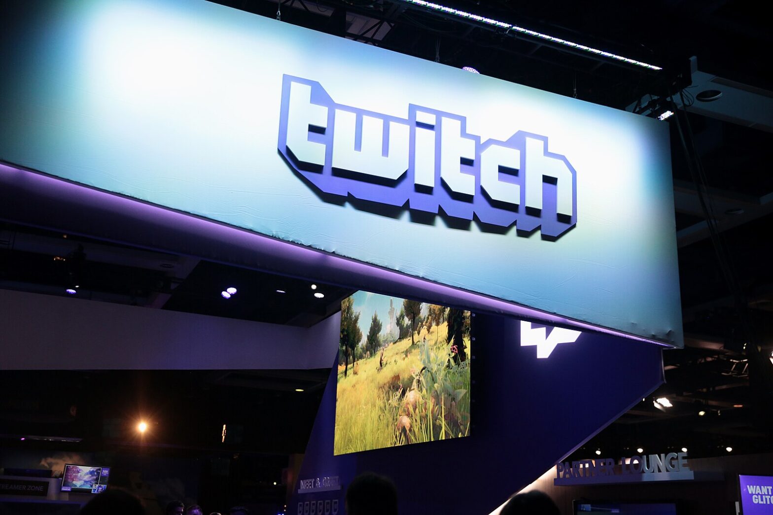 A white convention booth awning with the purple and white Twitch logo displayed.