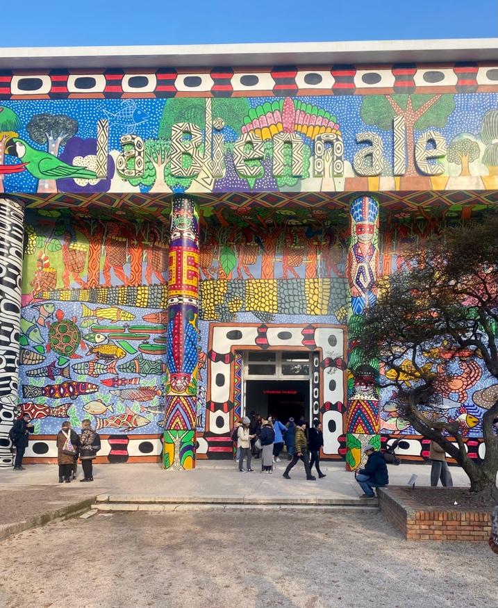 Photo of exhibition entrance with a colorful painted mural.